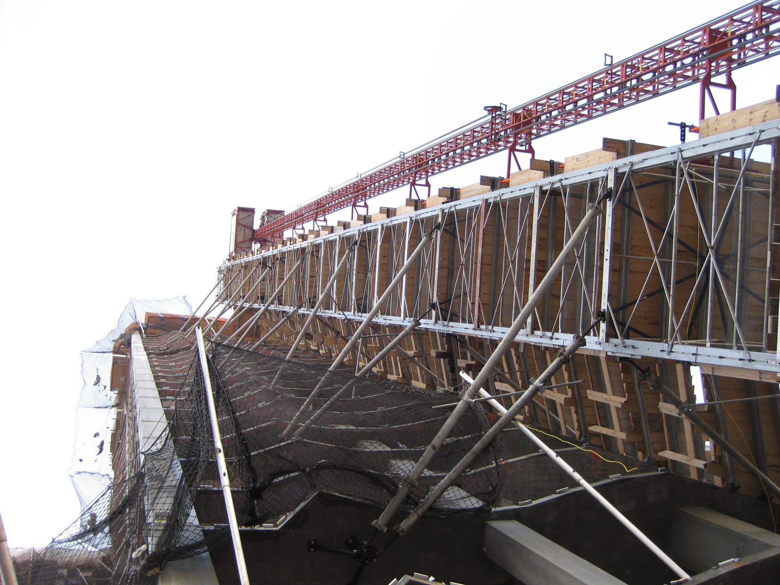 Image of scaffolding and safety nets on a building being constructed, view from below